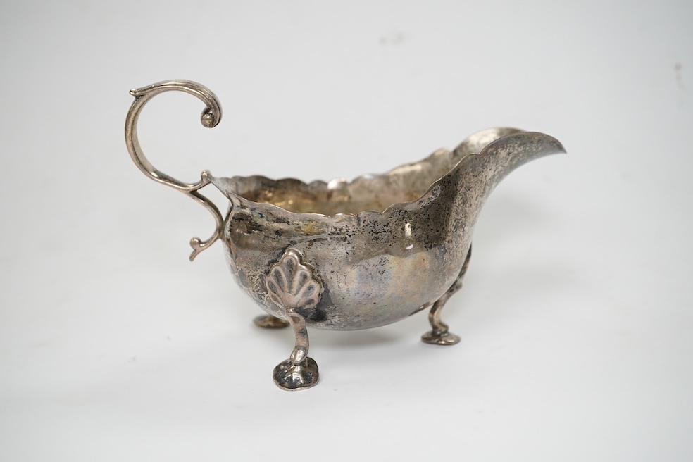 A Victorian silver sauce boat, London, 1876, length 14.2cm and metal quaich (adapted). Condition - poor to fair